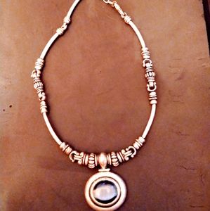 silver necklace with large blue stone
